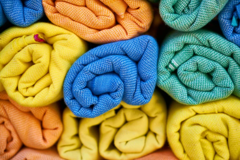 terry towels stacked in a cupboard
