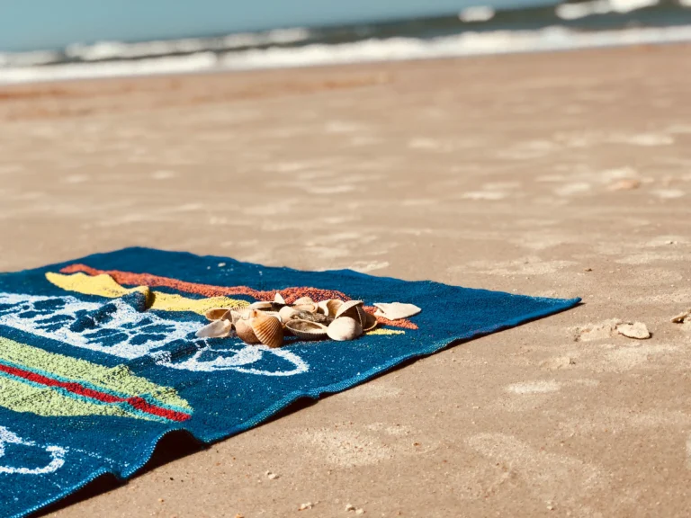 beach towel spread on a beach in a sunny day